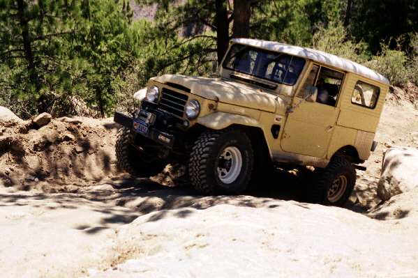 Rob's 1960 FJ25 catches a little air on the first hill